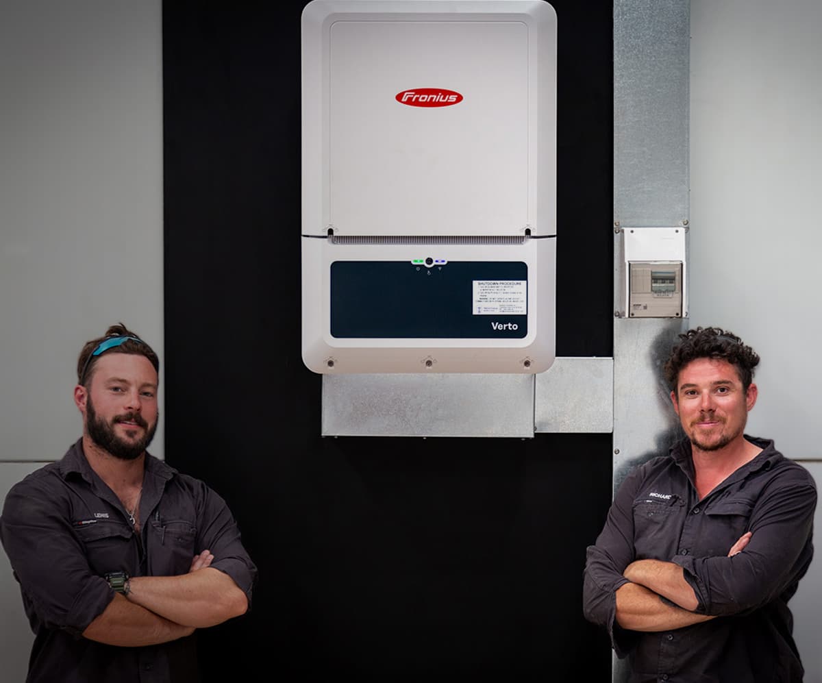 Two Eucalypt Solar electricians at an installed inverter